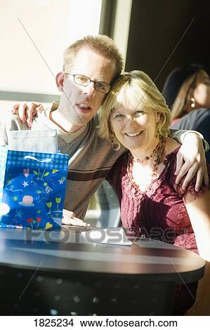 Picture - Mother and son with birthday gift. Fotosearch