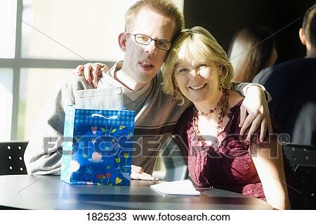 Stock Image - Mother and son with birthday gift. Fotosearch