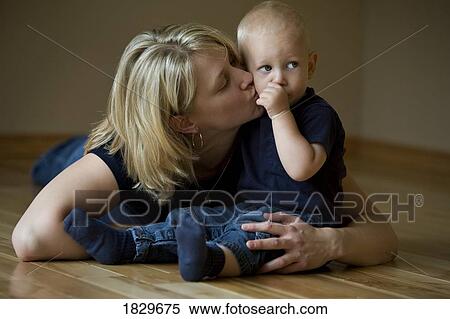 Stock Photography - Mother kissing her son. Fotosearch