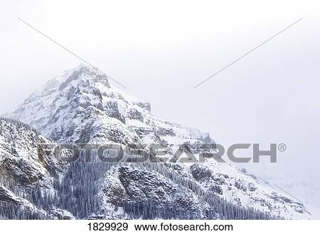 Mountain covered in snow, Lake Louise, Banff, Alberta, Canada View Large Photo Image Stock Photo - Mountain covered in snow, Lake Louise, Banff, Alberta, Canada. Fotosearch