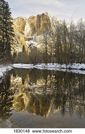 Stock Photo - Mountains reflecting in Merced River in winter, Yosemite National Park, USA. Fotosearch