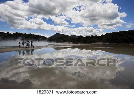 Stock Image - People at Champagne Pool, Wai-O-Tapu Thermal Wonderland, North Island, New Zealand. Fotosearch
