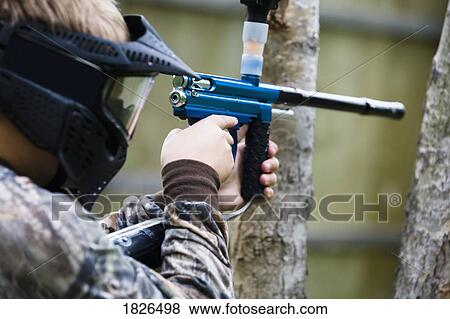 Stock Photo - Person aiming paintball gun. Fotosearch