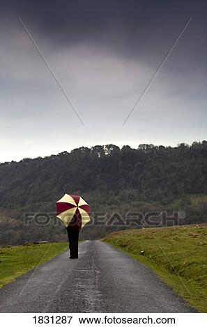 Stock Photo - Person with an umbrella. Fotosearch