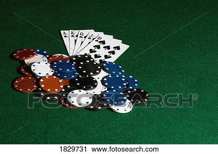 Stock Image - Pile of poker chips and cards on felt. Fotosearch