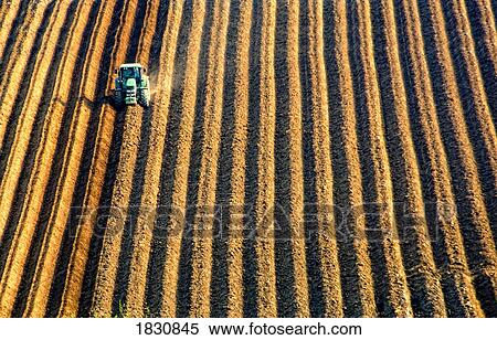Plowing a field View Large Photo Image Stock Photography - Plowing a field. Fotosearch