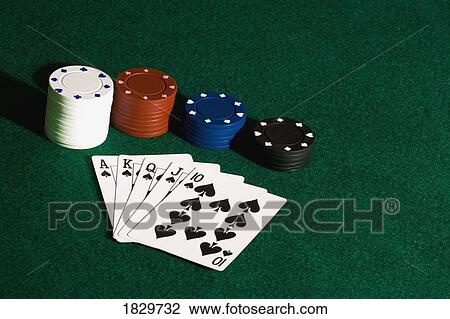 Stock Image - Poker chips and cards on felt. Fotosearch