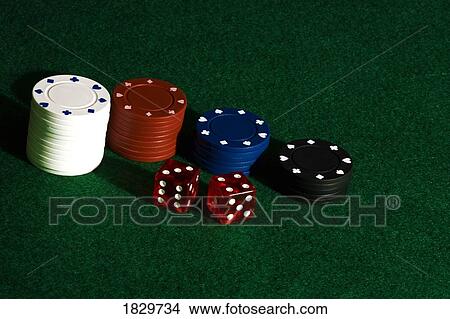 Picture - Poker chips and dice on felt. Fotosearch
