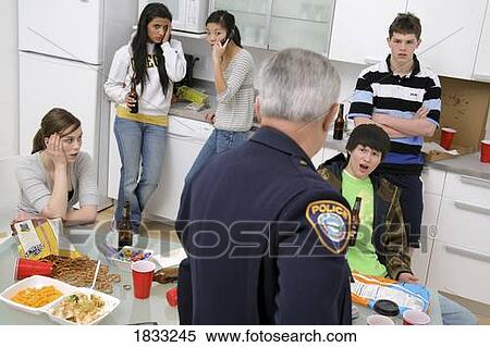 Police officer breaking up an under-age party View Large Photo Image Stock Photography - Police officer breaking up an under-age party. Fotosearch