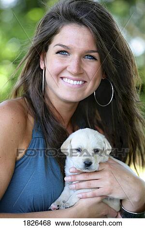 Stock Photo - Portrait of a woman and her puppy. Fotosearch