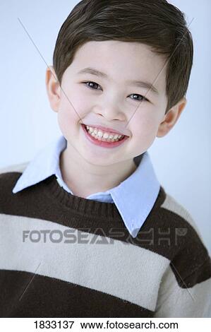 Portrait of young boy in striped shirt View Large Photo Image Stock Photo - Portrait of young boy in striped shirt. Fotosearch