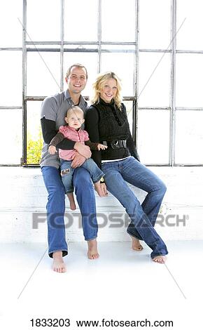 Portrait of young couple with baby View Large Photo Image Stock Image - Portrait of young couple with baby. Fotosearch