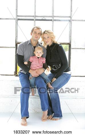 Stock Photo - Portrait of young couple with baby. Fotosearch