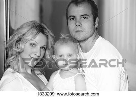 Portrait of young couple with baby View Large Photo Image Stock Photo - Portrait of young couple with baby. Fotosearch