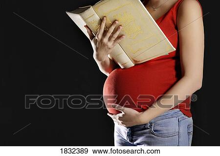 Pregnant woman reading a Bible View Large Photo Image Stock Photo - Pregnant woman reading a Bible. Fotosearch