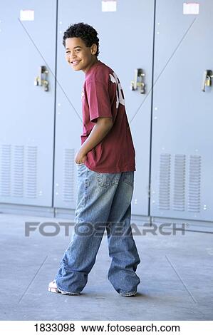 Stock Photo - Preteen boy in front of school lockers. Fotosearch
