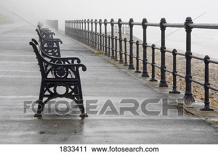 Stock Image - Redcar, North Yorkshire, England; Row of benches overlooking the beach and sea. Fotosearch