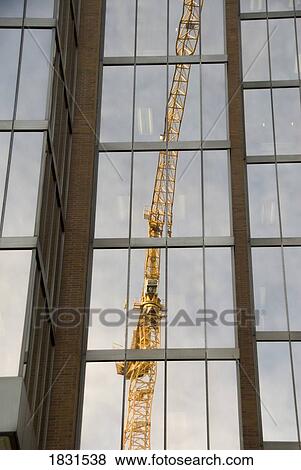 Stock Photo - Reflection of a crane in a highrise, Vancouver, British Columbia, Canada . Fotosearch