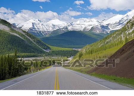 Stock Photo - Road in the Canadian Rocky Mountains, Alberta, Canada. Fotosearch