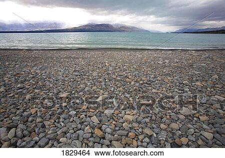 Rocky beach, Lake Pukaki, Southern Alps, New Zealand View Large Photo Image Picture - Rocky beach, Lake Pukaki, Southern Alps, New Zealand. Fotosearch