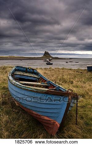 Row boat on the volcanic shore of Beblowe Craig, England View Large Photo Image Stock Photograph - Row boat on the volcanic shore of Beblowe Craig, England. Fotosearch
