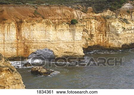 Stock Image - Sea rock stack arch near 12 Apostles, Australia . Fotosearch