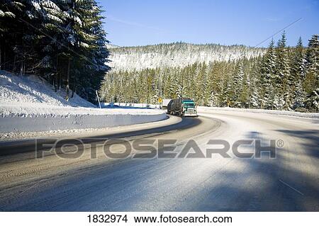 Semi truck driving on a winter road View Large Photo Image Picture - Semi truck driving on a winter road. Fotosearch