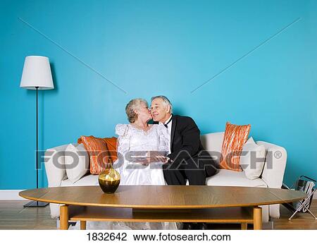 Stock Image - Senior bride and groom in living room . Fotosearch
