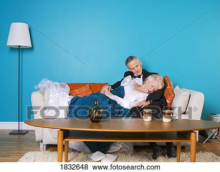 Senior couple reading on the couch together View Large Photo Image Stock Photo - Senior couple reading on the couch together. Fotosearch