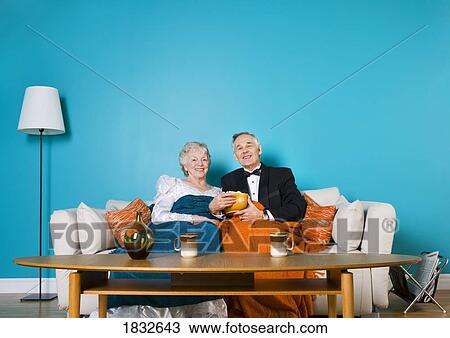 Senior couple relaxing on the couch View Large Photo Image Stock Image - Senior couple relaxing on the couch. Fotosearch