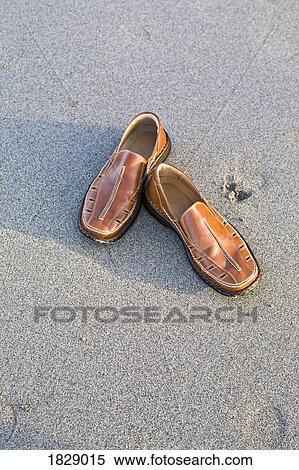 Stock Photography - Shoes on sand. Fotosearch