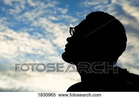 Silhouette of a man looking into the clouds View Large Photo Image Stock Photography - Silhouette of a man looking into the clouds. Fotosearch