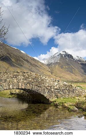 Picture - Stone bridge in mountain landscape, Lake District, Cumbria, England. Fotosearch