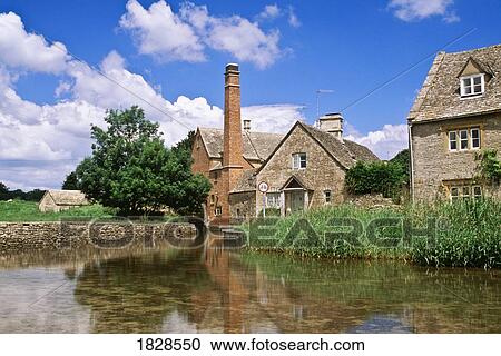 Stock Image - Stone mill and houses, Lower Slaughter, Cotswolds, England. Fotosearch