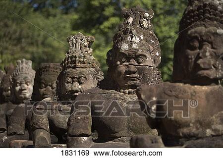 Stock Photo - Stone statues, city of Angkor Wat, northwestern Cambodia. Fotosearch