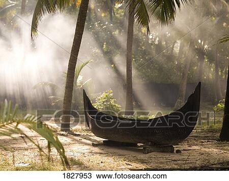 Stock Image - Sunlight shining on a canoe. Fotosearch