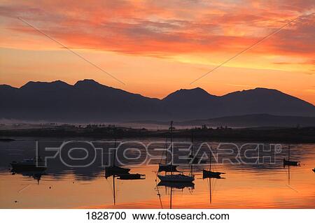 Stock Image - Sunrise at Roundstone Harbour with 12 Bens, Galway, Ireland. Fotosearch