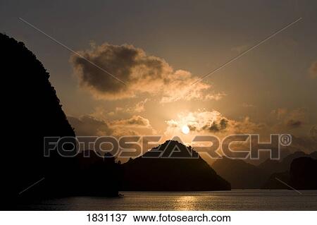 Sunset in Halong Bay islands in the Gulf of Tonkin, Vietnam View Large Photo Image Stock Photo - Sunset in Halong Bay islands in the Gulf of Tonkin, Vietnam. Fotosearch