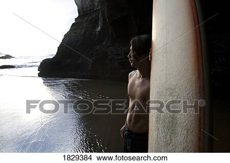 Surfer at Muriwai, New Zealand View Large Photo Image Picture - Surfer at Muriwai, New Zealand. Fotosearch