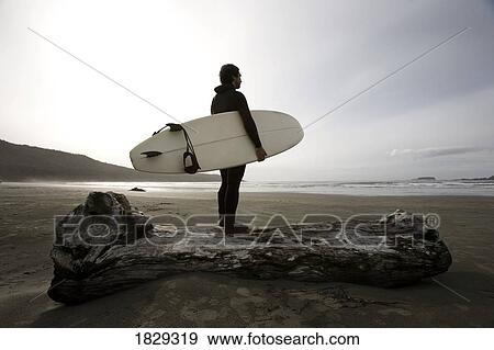 Stock Photo - Surfer on beach. Fotosearch