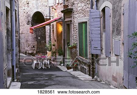 Tables and chairs on small street, Grignan, Provence, France View Large Photo Image Stock Image - Tables and chairs on small street, Grignan, Provence, France. Fotosearch