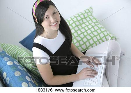 Teenage girl using laptop View Large Photo Image Stock Photograph - Teenage girl using laptop. Fotosearch