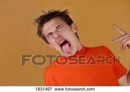 Stock Photo - Teenager sticking tongue out . Fotosearch
