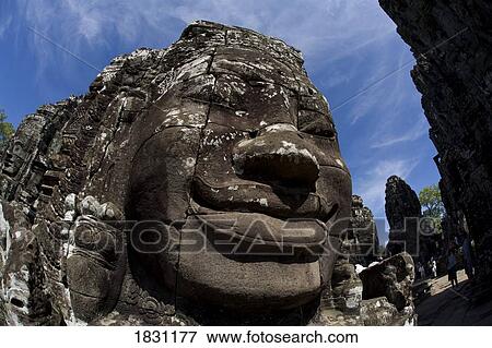 Stock Photo - The faces of the Bayon temple in the ancient city of Angkor, in northwestern Cambodia. Fotosearch