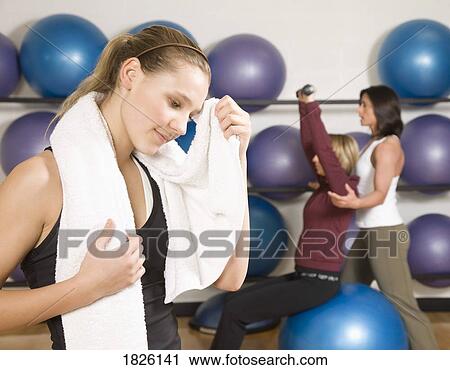 Stock Image - Three women exercising. Fotosearch