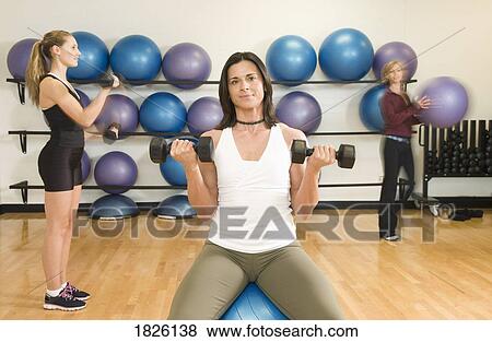 Stock Photo - Three women exercising. Fotosearch