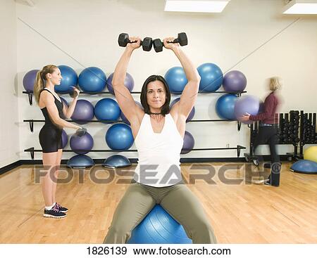 Stock Photo - Three women exercising. Fotosearch