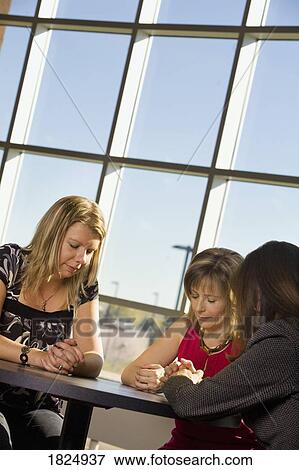 Three women praying View Large Photo Image Stock Photo - Three women praying. Fotosearch