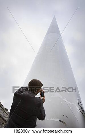 Tourist taking picture of the Spire of Dublin, Dublin, Ireland View Large Photo Image Stock Photo - Tourist taking picture of the Spire of Dublin, Dublin, Ireland. Fotosearch