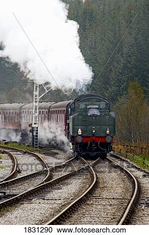Stock Image - Train on railroad tracks, Grosmont, North Yorkshire, England. Fotosearch